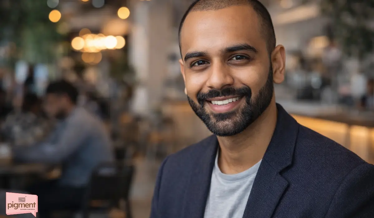 Stylish Indian man with a receding hairline sporting a confident buzz cut and groomed beard.